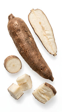Fresh raw cassava root pieces isolated on a white background.
