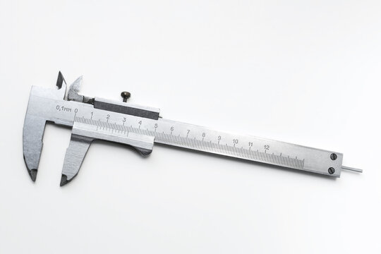 Vernier caliper precision measuring metal instrument isolated on white background to illustrate industrial quality control and manufacturing. Real Photo