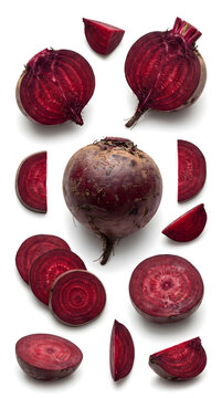 Fresh whole and sliced red beetroots arranged on a white background.