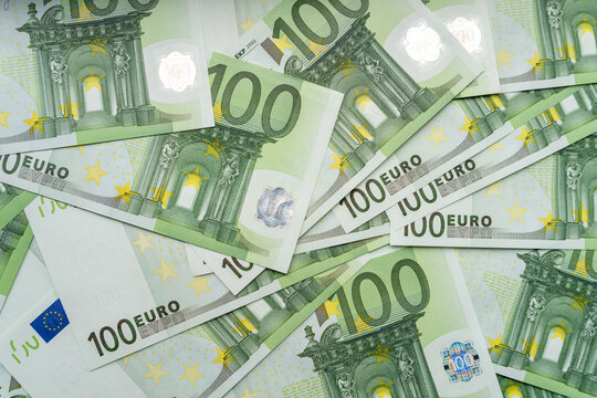 100-euro banknotes, scattered at random as monetary background. Background of money. Currency of European Union. Financial savings, investments and purchases. Real Photo
