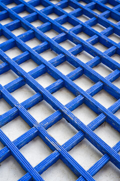 Diagonal view of blue painted wooden lattice pattern with traditional paper at a serene korean buddhist temple.