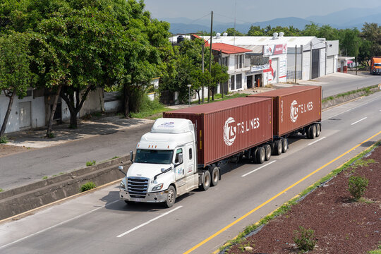 Red T.S. Lines containers transported on highway by truck, owned by T.S. Lines Limited. Jalisco, Mexico, July 20, 2026.   