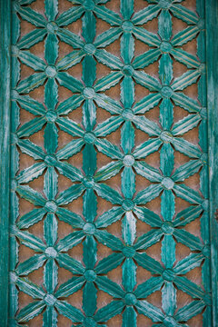 Full frame background of traditional green wooden floral lattice door pattern at Buddhist temple hall in South Korea.