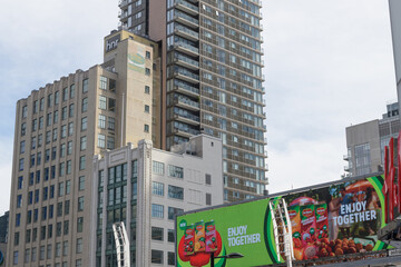 Obraz premium digital billboard featuring advertising for Del Monte beverages and view of historic buildings Hermant Building / HNR Properties Limited (Imperial Optical) located at 19 and 21 Dundas Square, Toronto