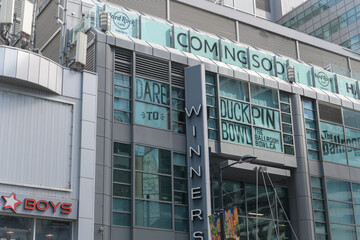 Obraz premium exterior of The Tenor with Ballroom Bowl, coming soon signage of Hard Rock Cafe and Winners, a department store, and other signage, outside Yonge St side of 10 Dundas St E, Toronto