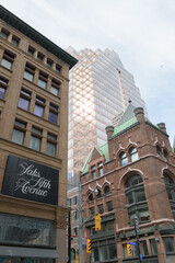 Obraz premium historic and modern architecture in Toronto: Confederation Life Building (1892), Simpson Department Store (1895) & One Queen Street East, a business center