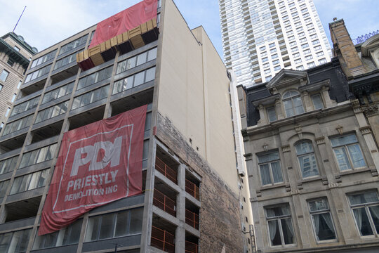 old office building being partly demolished at 55 Yonge St and facade of historic Contor House and contrast with 88 Scott Street/20 Wellington Street East, an office and residential tower, Toronto