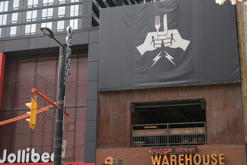 Fototapeta premium exterior building facade and signs of Jollibee, a chicken restaurant, and The Yonge St Warehouse, Toronto