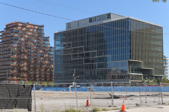 distant view of Aqualuna Condos, located at 155 Merchants' Wharf, and T3 Bayside, a corporate office located at 251 Queens Quay E, Toronto