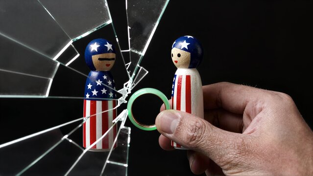 Hand holds ring as shattered glass breaks between patriotic figurines, symbolizing broken promises.
