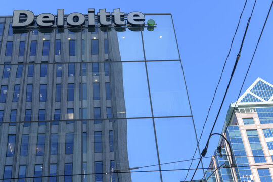 sign outside Deloitte Canada, an accounting firm, located here at 8 Adelaide St W, northwest corner of Yonge St, Toronto        