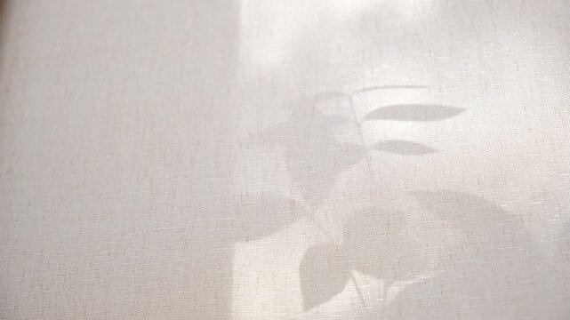 Crossed lines of shadows on beige fabric add quiet rhythm to the composition, while the vintage textile tells a story of time. The interplay of light and shadow creates a dreamy, nostalgic atmosphere