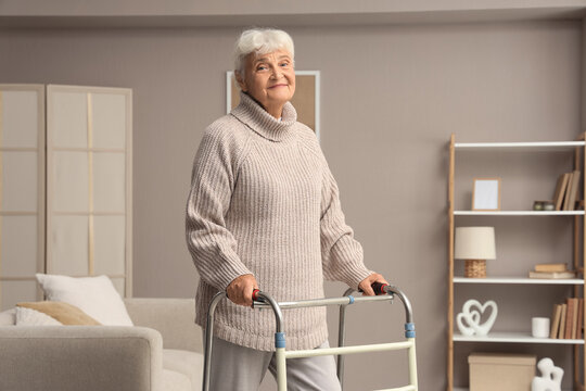 Healthy aging and senior mobility, happy elderly woman using a walker for independence and support in a comfortable home living room environment
