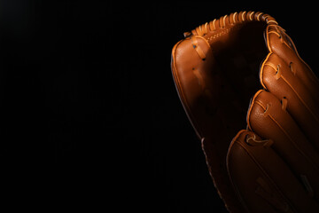 Baseball sports competition and teamwork, leather glove for professional game on dark background with dramatic lighting for athletic training © Pixel-Shot