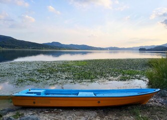 Peaceful Lake Nature Landscape with Small Wooden Boat Anchored at Semiwon Riverside in Yangpyeong © JeongHwa