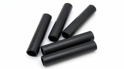 Fototapeta premium Several black cylindrical tubes arranged on a white background, suggesting industrial or scientific applications