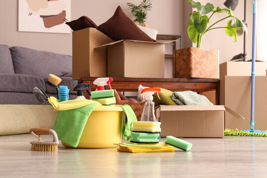 Moving house cleaning service, professional deep cleaning supplies and cardboard boxes in a new home for relocation and residential maintenance