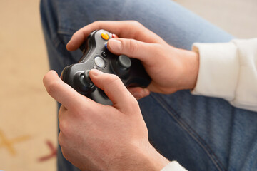 Gaming addiction and digital entertainment, person playing video games with a controller at home for leisure and interactive media engagement © Pixel-Shot