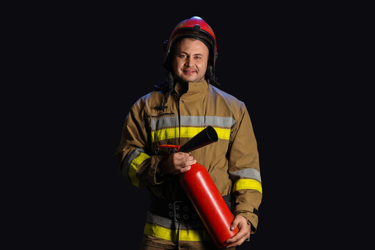 Fire safety and emergency response, professional firefighter holding a fire extinguisher for workplace protection and hazard prevention on black background