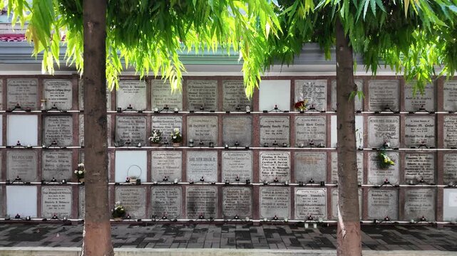 Cemetery columbarium wall behind trees, Dumaguete, Philippines