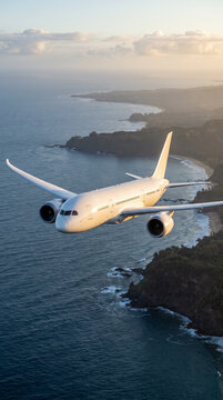Passenger Jet Flying Over Tropical Shoreline and Blue Sea