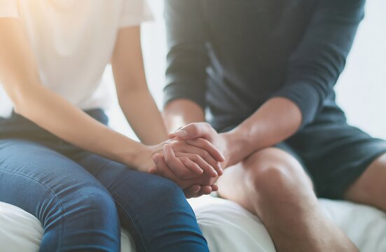 Couple holding hands in bedroom showing comfort and support with empathy and love in connection