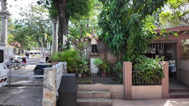 Statue of Saint Pedro Calungsod in church courtyard garden, Dumaguete, Philippines