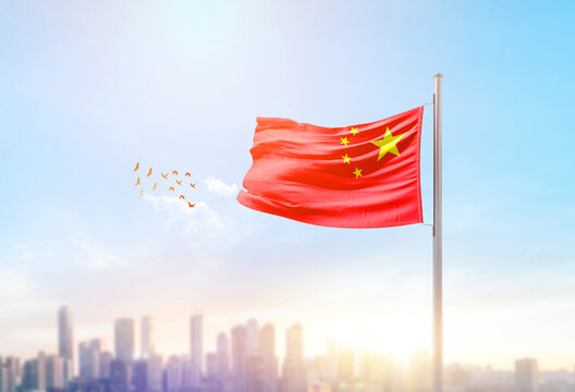 China national flag waving with skyline and buildings.