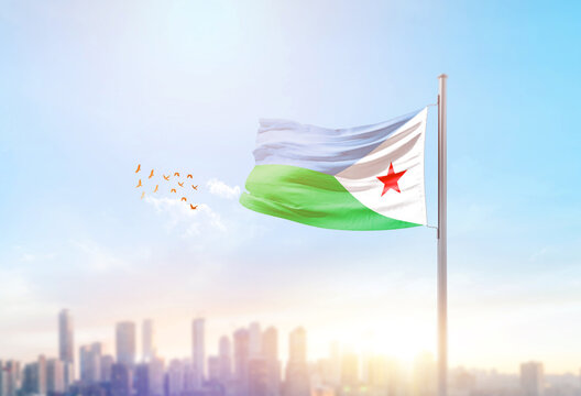 Djibouti national flag waving with skyline and buildings.