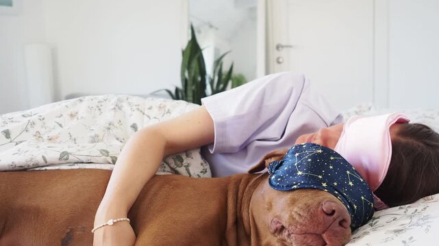 Woman and brown Pit Bull sleeping in bed wearing sleep masks. Daytime sleep. Pet care, comfort, and love. Symbolizes deep bond and caring for animals. Ideal for pet lifestyle content