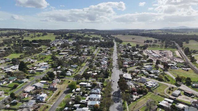 Aerial drone view of Beaufort Victoria, Australia. Small regional township along Western Highway, with residential streets, houses farmland and hills in distance. Major interstate transport corridor