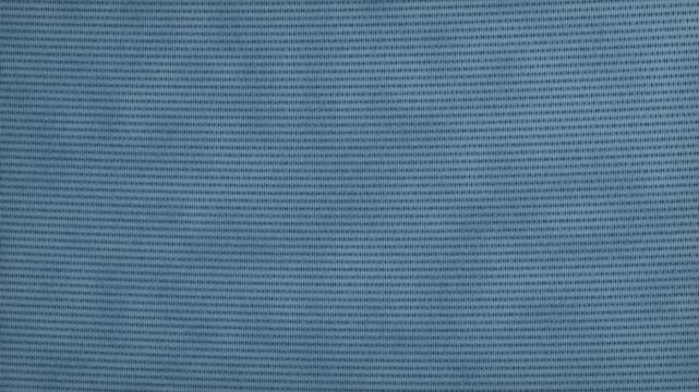Premium macro close-up of deep indigo denim featuring a continuous chevron herringbone weave, dimensional interlocking yarns, directional cotton fibers, subtle stonewashed texture, and a soft diagonal