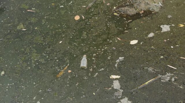 Polluted shallow river with sediment and wastewater discharge, symbolizing human impact, environmental destruction, ecosystem degradation, water contamination.