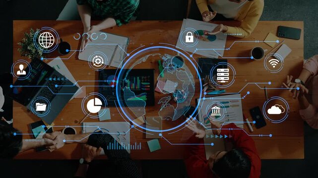 Business Team Collaborating on Digital Solutions with Technology Icons and Global Connectivity Overlaid on Table Full of Devices and Documents. Entropy.