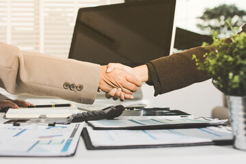 Business people shaking hands finishing up a meeting. Two confident businessman shaking hands during a meeting in the office, success, dealing, greeting and partner concept. © Natchanida