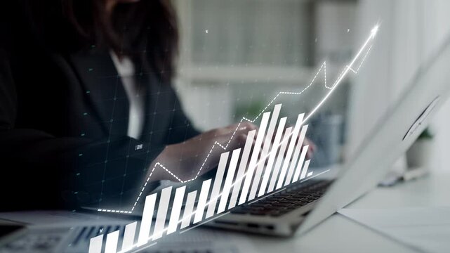 A business professional engages with data analysis using a laptop in a modern office, with a visually appealing upward trending graph representing growth and success. Copula