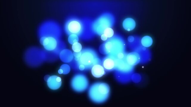 Blue glowing bokeh lights dance softly on dark background, abstract motion background for celebrations