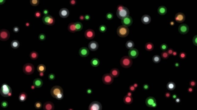 Colorful glowing particles dance and float on black background festive abstract motion