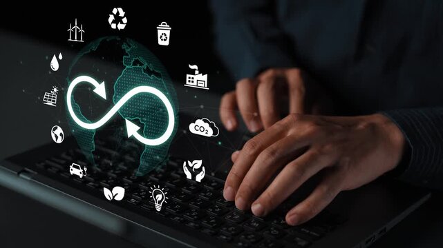 Hands typing on laptop with eco symbols representing recycling, sustainability, and digital technology overlaid on a globe in a modern workspace environment. Entropy.