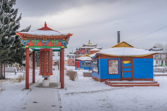 Buryatia landmark &mdash; snowy winter scene at Ivolginsky Datsan in Russia, near Ulan Ude city, with colorful Buddhist temples, traditional roofs, and a peaceful sacred setting.
