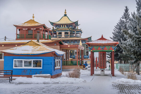 Buryatia landmark &mdash; snowy winter scene at Ivolginsky Datsan in Russia, near Ulan Ude city, with colorful Buddhist temples, traditional roofs, and a peaceful sacred setting.
