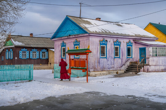 Ivolginsky Datsan courtyard in Buryatia, Russia, with wooden Buddhist buildings, temple architecture, and red prayer drums.
