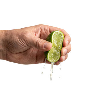 Human hand squeezing a fresh green lime to extract juice.