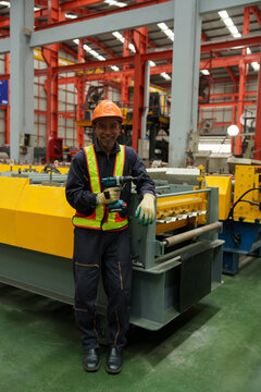 Engineers and staff are inspecting the assembly line system in a metal sheet and metal roofing manufacturing plant.	