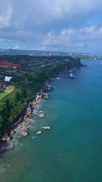 Stunning ocean cliffs and resorts. Vast seaside landscape with rocky formations. Majestic seafront cliffs accompanied by elegant retreats and rugged natural features, Jimbaran,Bali