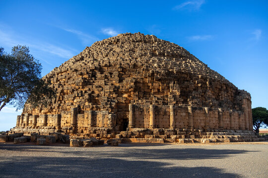 Ancient Circular Stone Mausoleum at Golden Hour Under a Blue Sky, Tipaza, Algeria