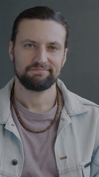 Slow motion portrait of guy shaking head meaning No rejecting bad offer looking at camera on black studio background. People and face expression concept.