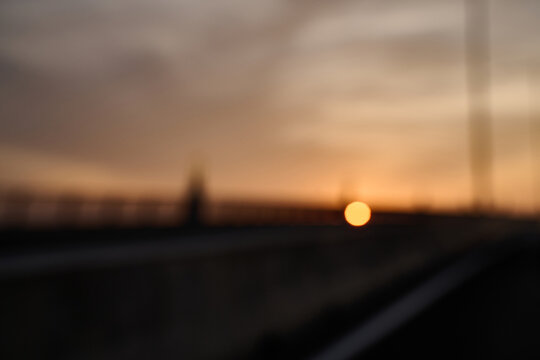 Blurred Sunrise on Bridge Symbolizing a New Beginning