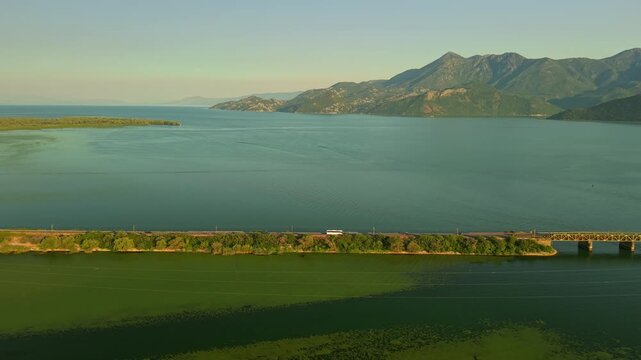 Small Boat Wake on Skadar Lake Between Rocky Islets