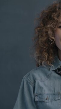 Portrait of joyful young lady showing OK hand gesture expressing satisfaction smiling on black studio background. People and emotion concept.